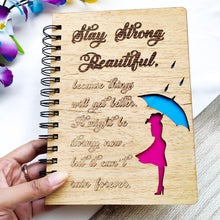 Load image into Gallery viewer, Laser cut and engraved wooden diary with Girl with an umbrella design and a beautiful quote