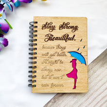 Load image into Gallery viewer, Laser cut and engraved wooden diary with Girl with an umbrella design and a beautiful quote